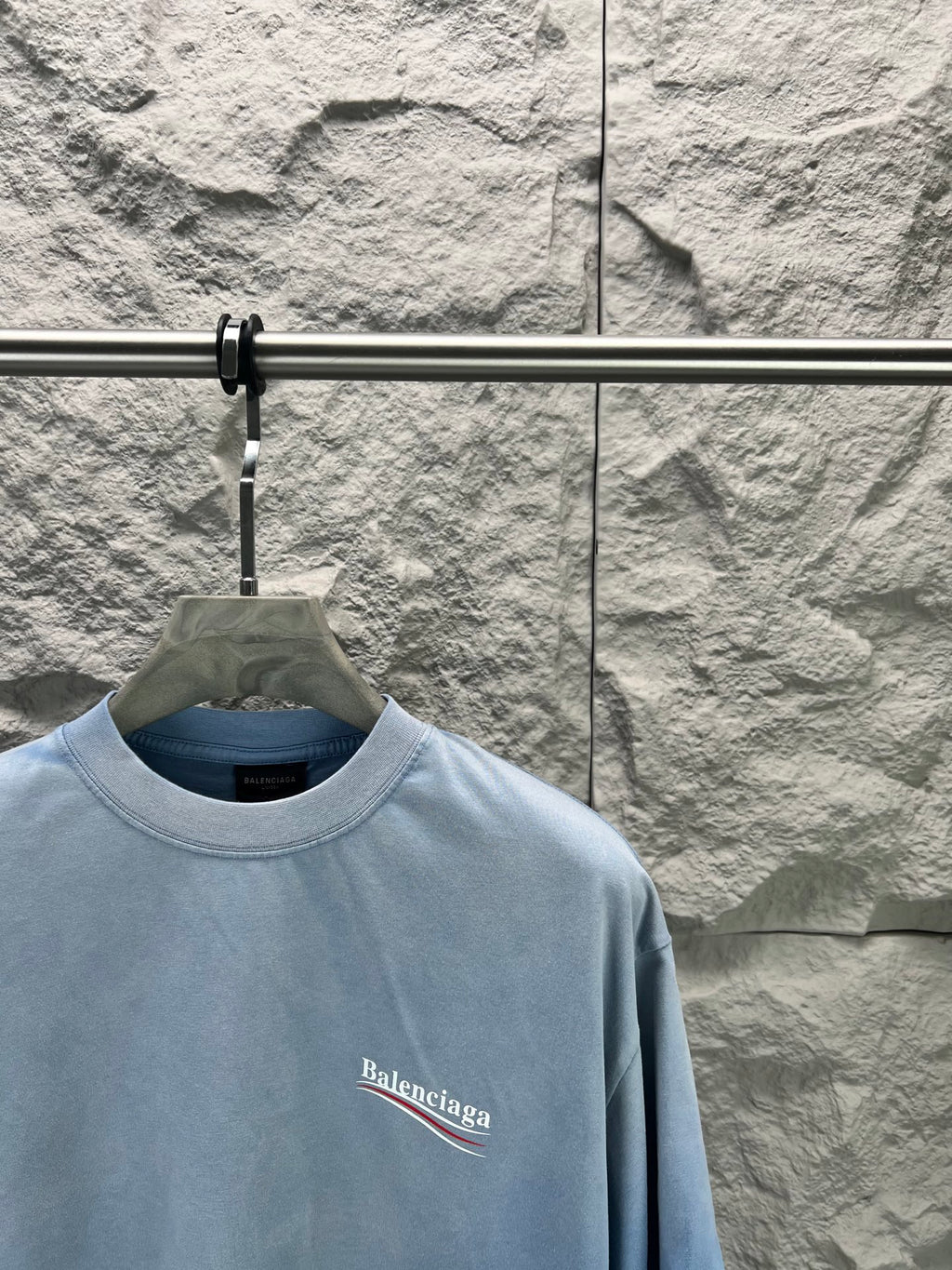Light blue short-sleeve T-shirt with Balenciaga logo print on the chest.