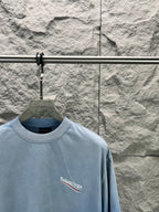 Light blue short-sleeve T-shirt with Balenciaga logo print on the chest.