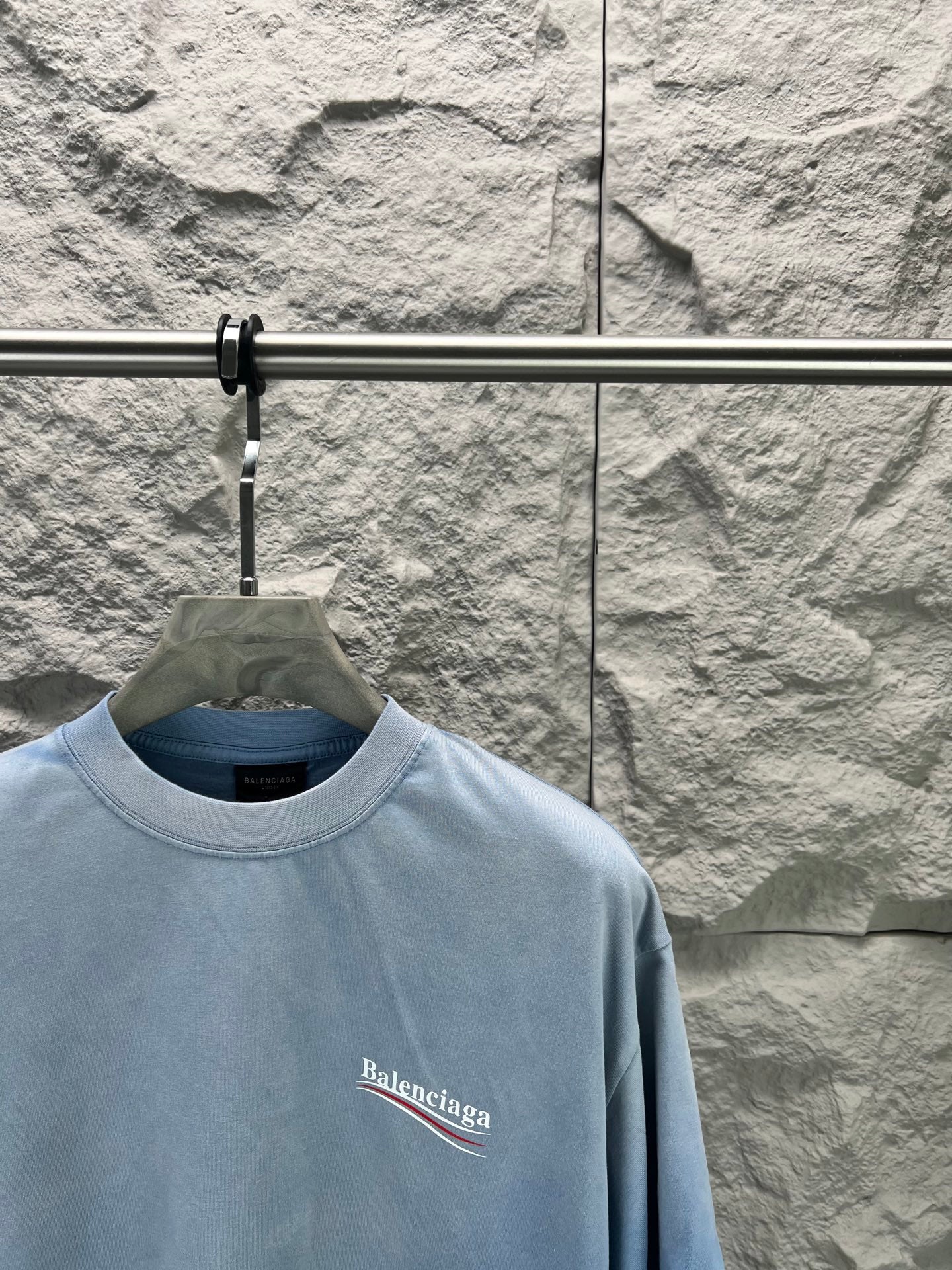 Light blue short-sleeve T-shirt with Balenciaga logo print on the chest.