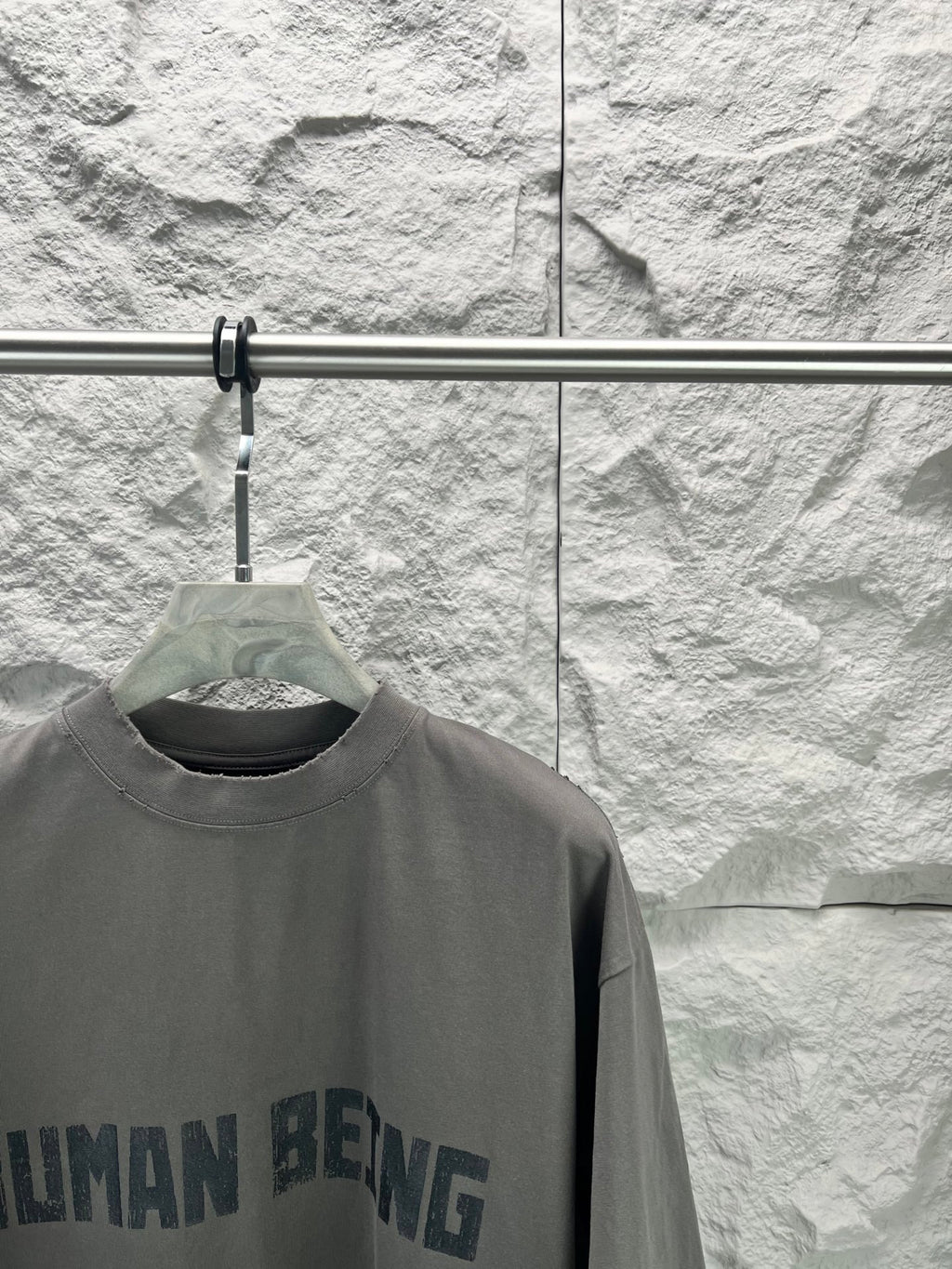 Crew-neck T-shirt, dark gray, partial front graphic text print close-up.