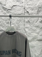Crew-neck T-shirt, dark gray, partial front graphic text print close-up.
