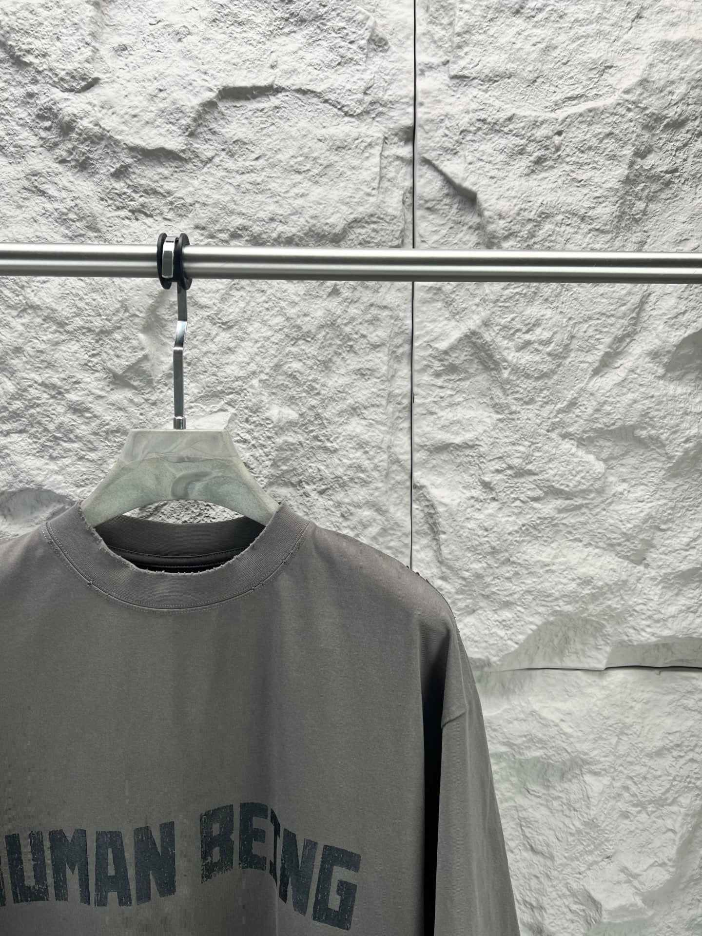Crew-neck T-shirt, dark gray, partial front graphic text print close-up.