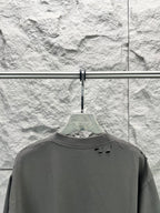 Crew-neck T-shirt, dark gray, short sleeves, small distressed holes near back yoke.