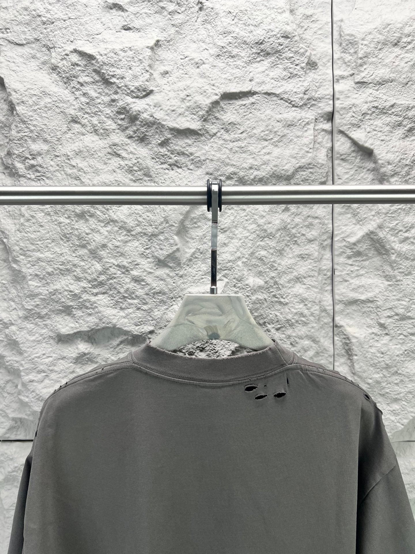 Crew-neck T-shirt, dark gray, short sleeves, small distressed holes near back yoke.