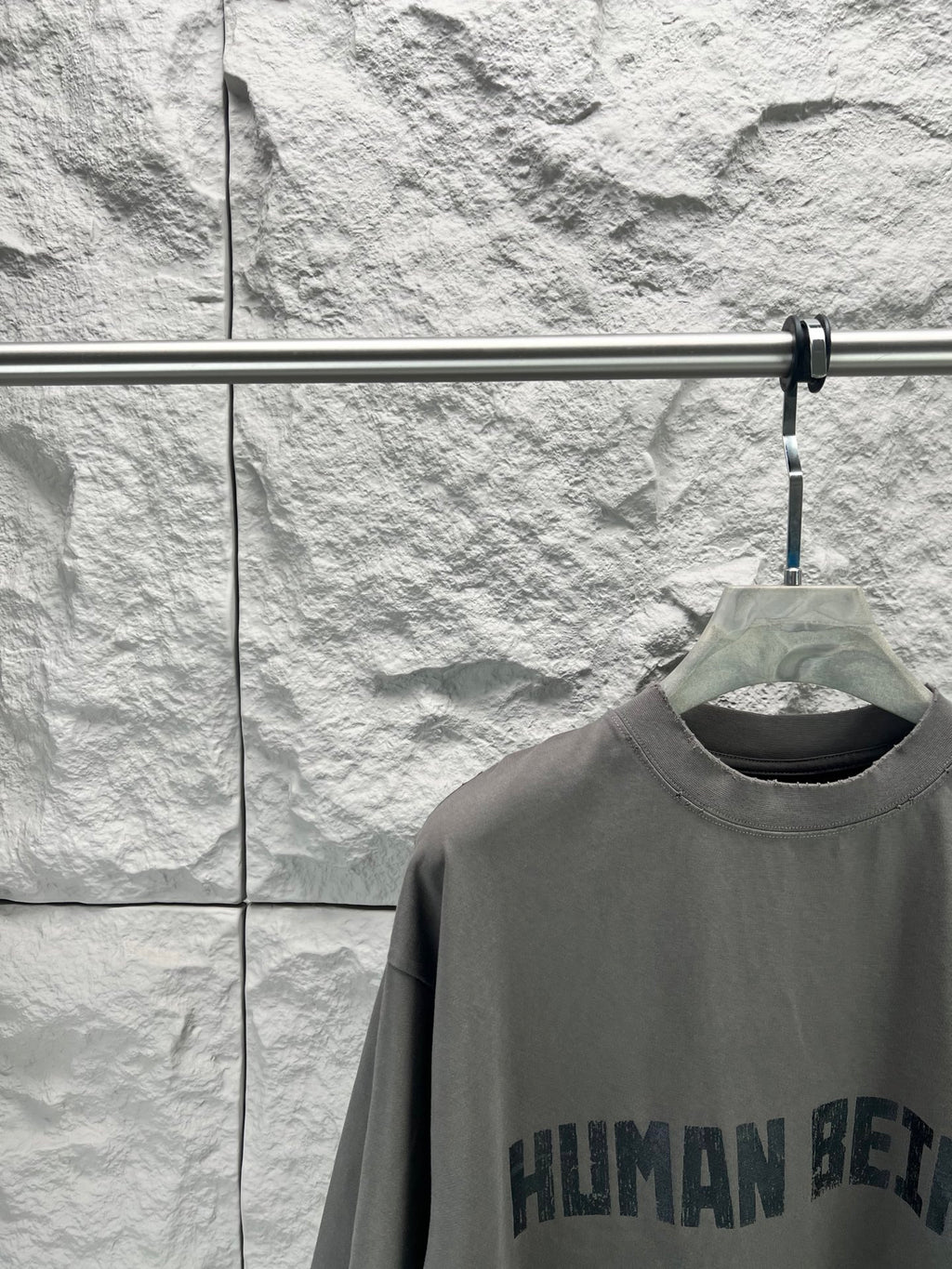 Crew-neck T-shirt, dark gray, front graphic text print close-up at chest.