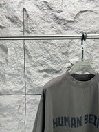 Crew-neck T-shirt, dark gray, front graphic text print close-up at chest.