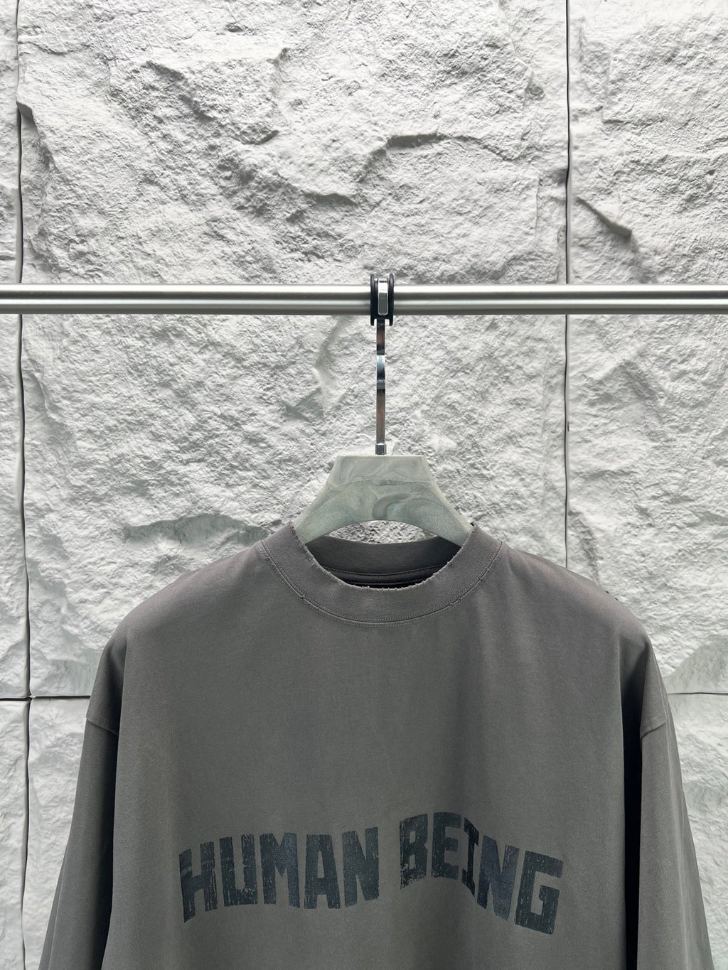 Crew-neck T-shirt, dark gray, front graphic text print close-up.