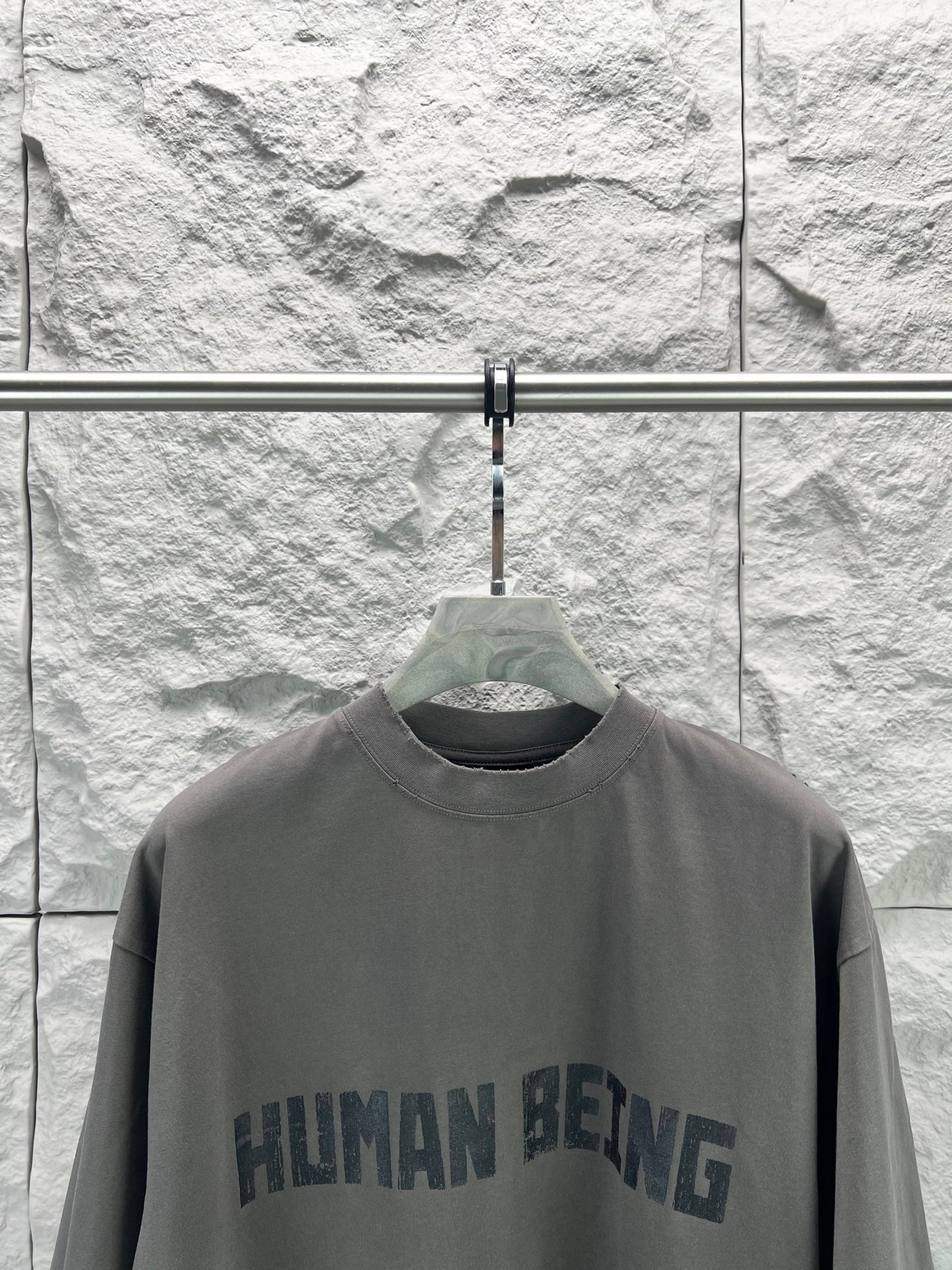 Crew-neck T-shirt, dark gray, front graphic text print close-up.