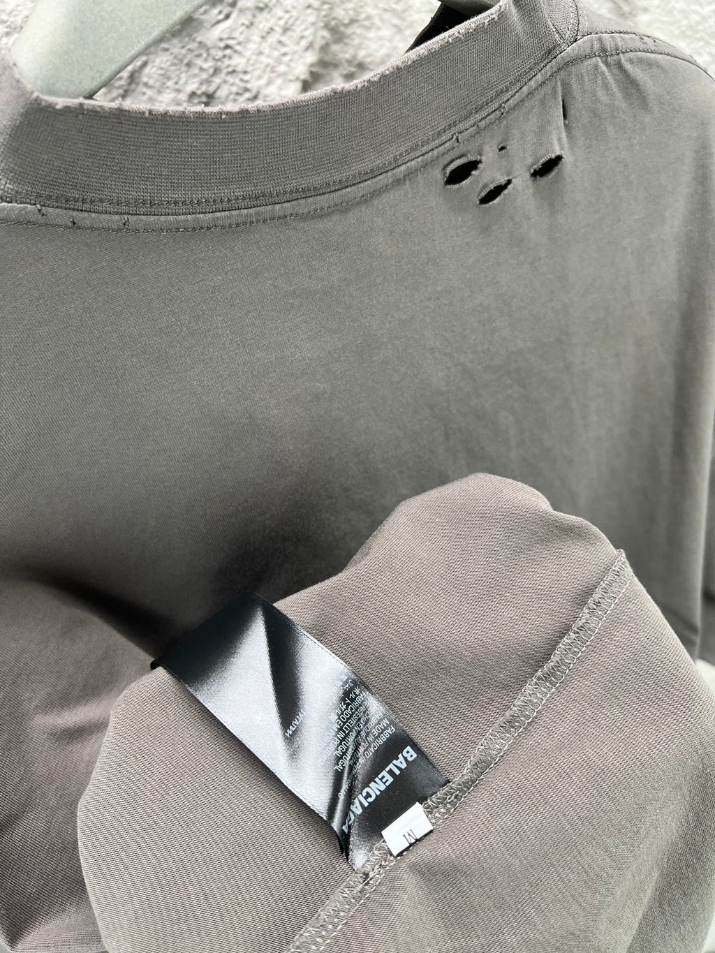 Crew-neck T-shirt collar detail with interior label and stitched neck seam.
