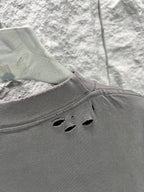 Crew-neck T-shirt, dark gray, distressed cutout holes along the back shoulder area.