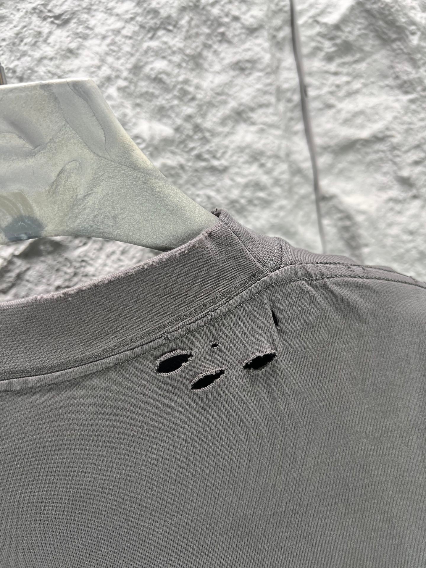Crew-neck T-shirt, dark gray, distressed cutout holes along the back shoulder area.