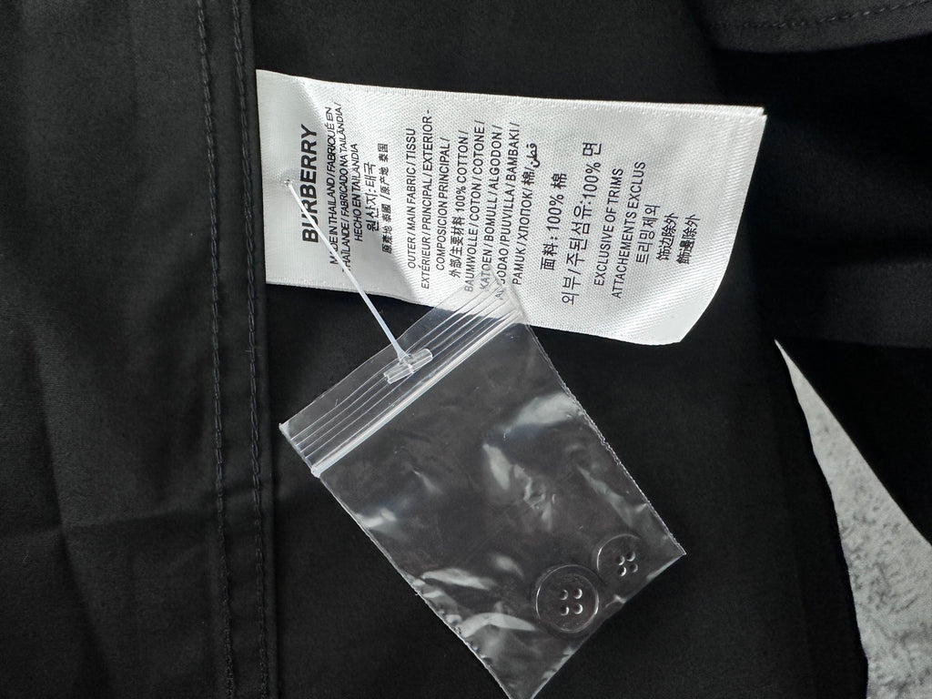 Long-sleeve button-up shirt inside label with care info and barcode tags