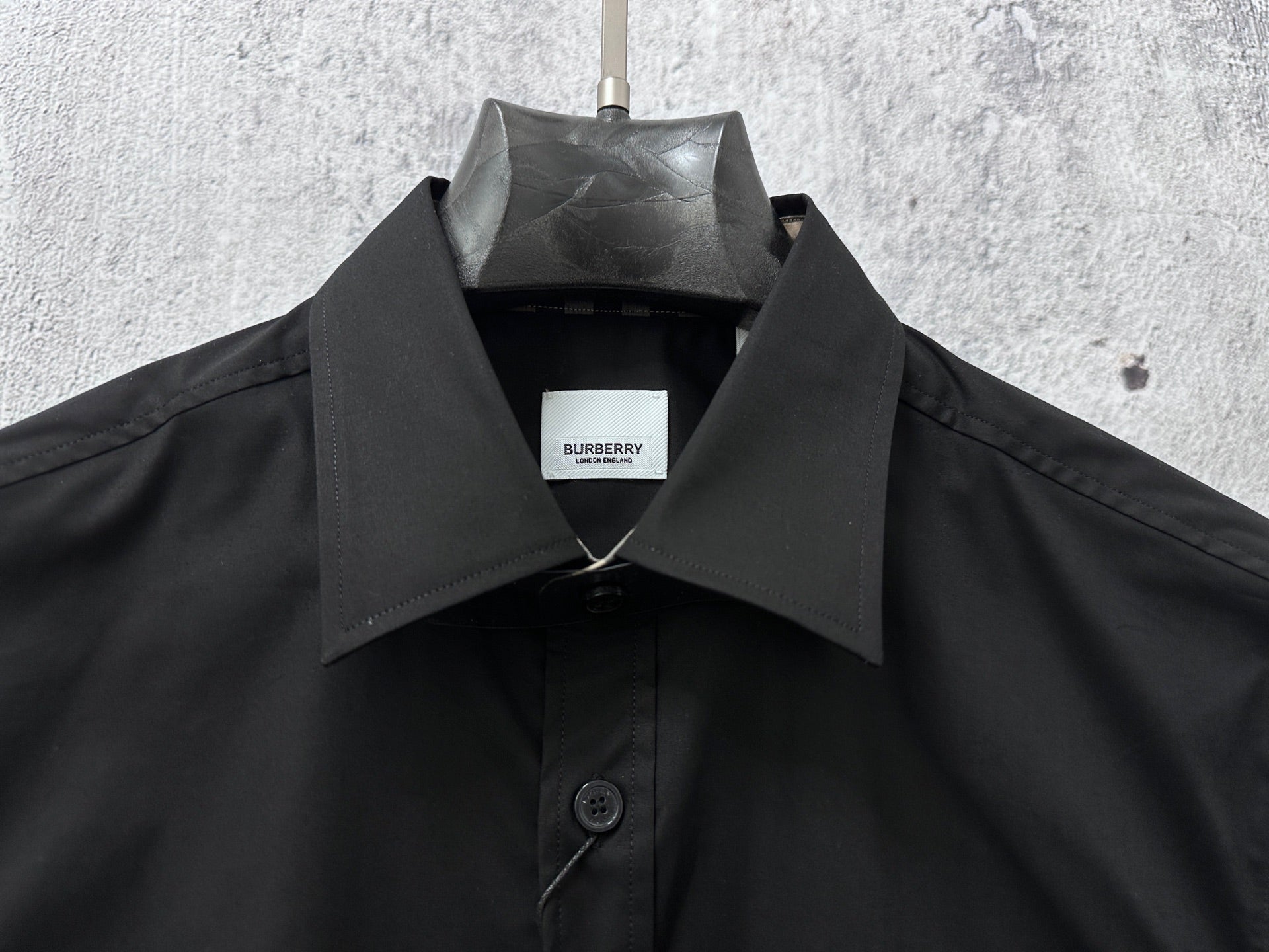 Burberry dark long-sleeve shirt neckline with hanging interior brand tag