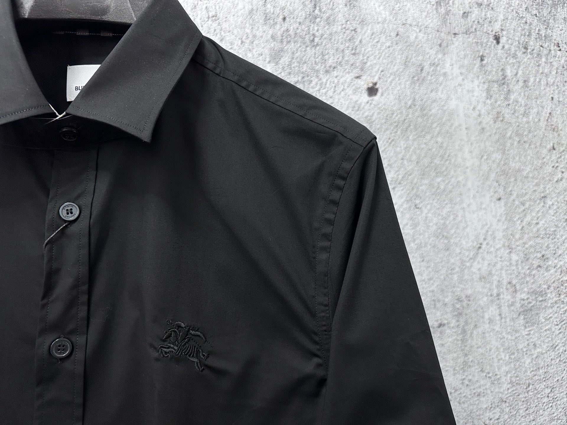 Burberry dark shirt collar and button placket with small embroidered logo detail
