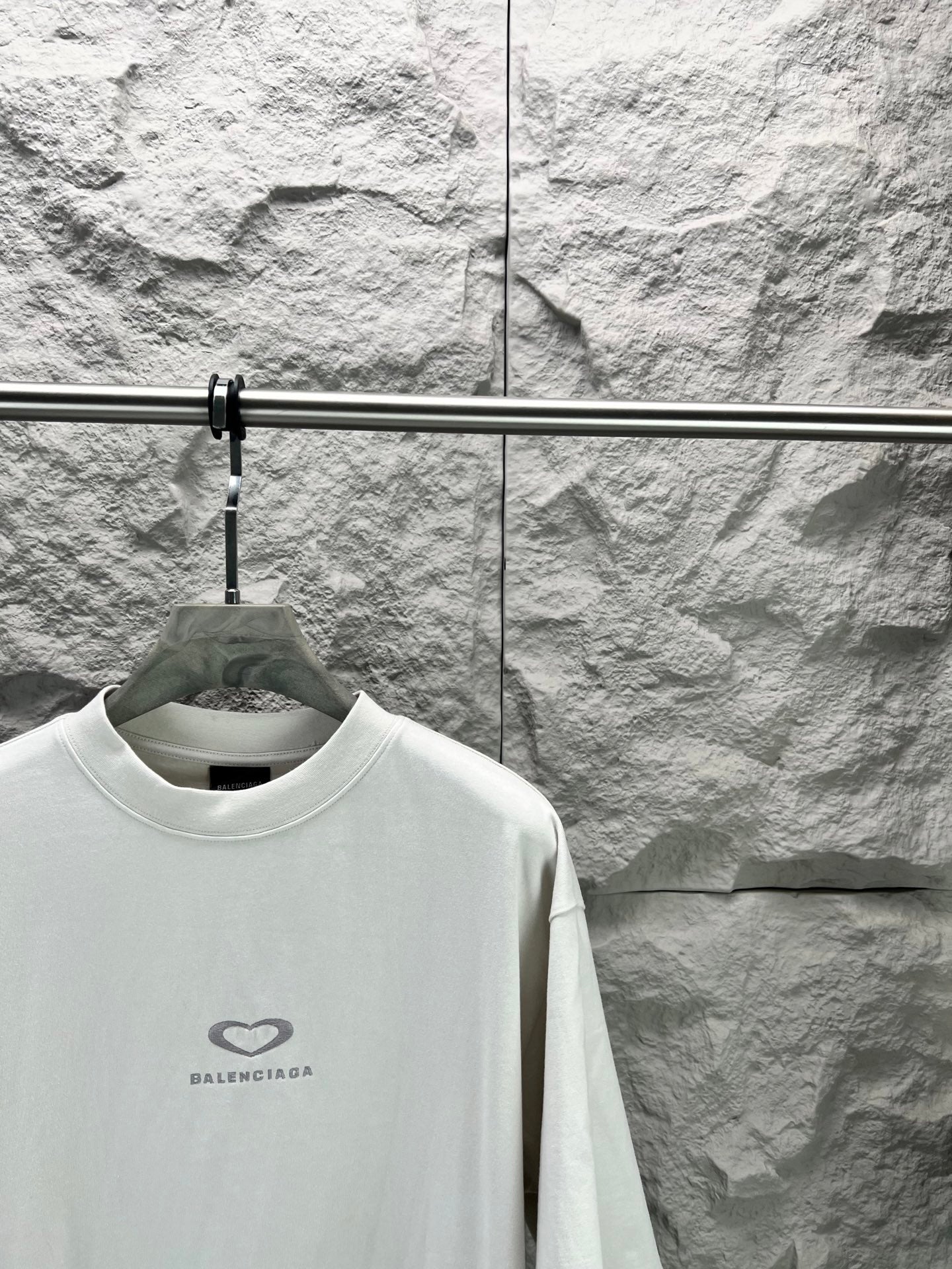Balenciaga short-sleeve T-shirt in white with heart logo at chest, angled view