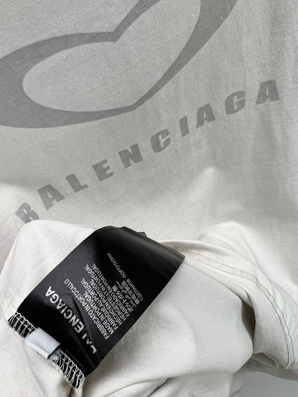 White Balenciaga T-shirt hem with black care label and small text