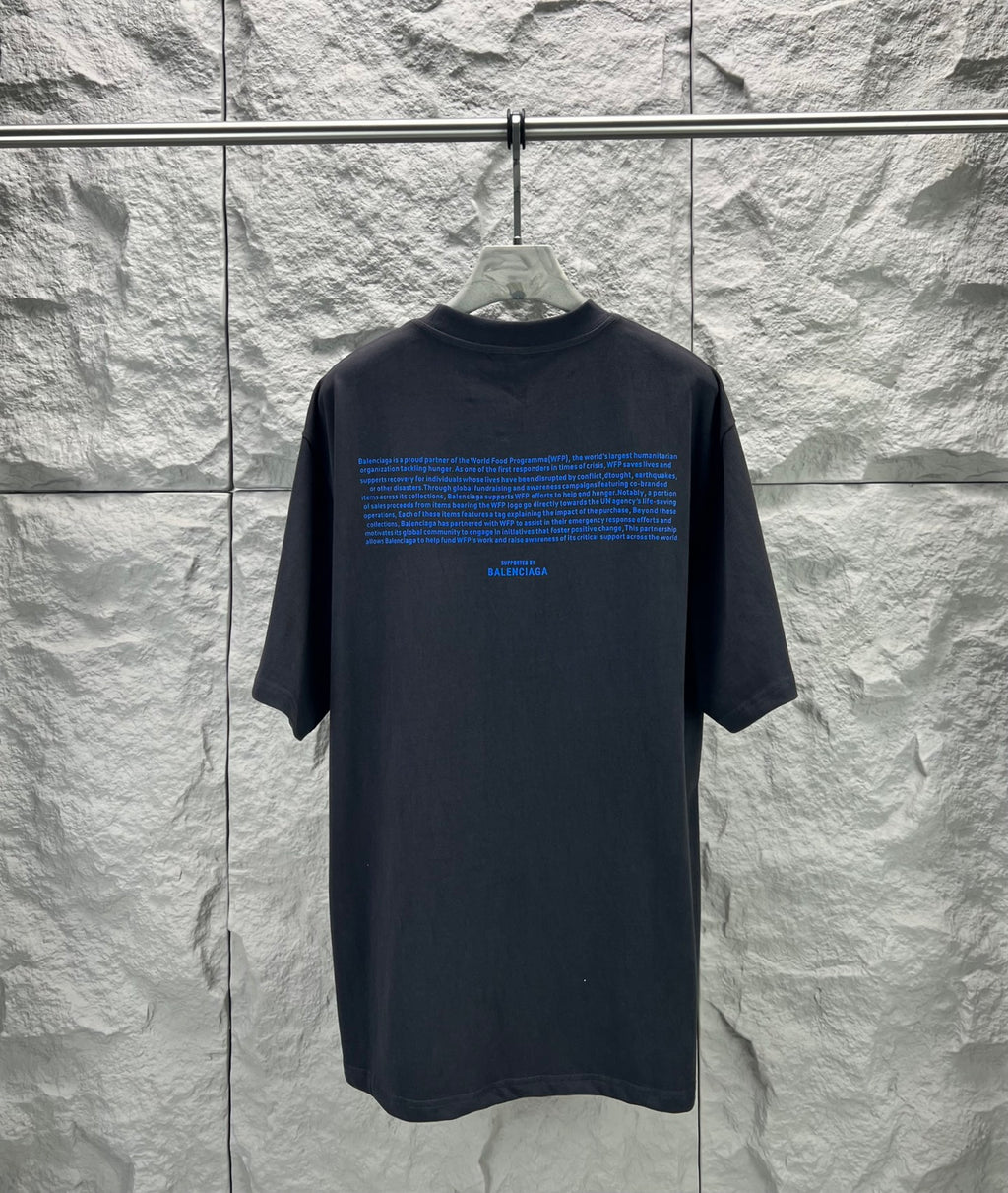 Black short-sleeve T-shirt with crew neck and blue back text graphic