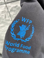 Gray T-shirt sleeve with blue laurel and text “World Food Programme” print