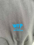 Gray T-shirt chest with blue “WFP” and “Supreme by BALENCIAGA” text