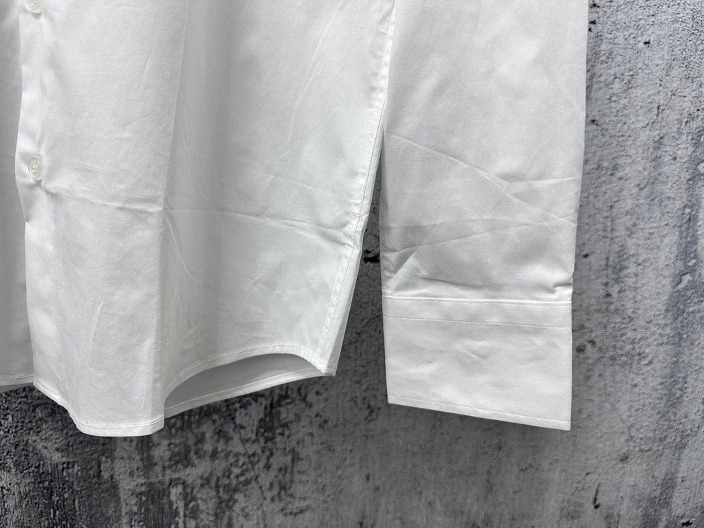 White long-sleeve shirt hem with side vents