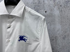 White shirt with embroidered blue horse logo on chest