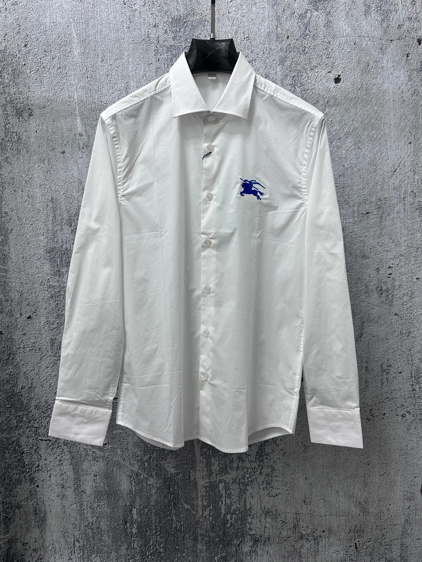 White long-sleeve button-up shirt with blue horse logo on chest