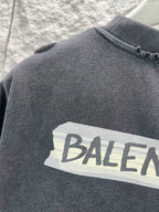Dark heather T-shirt with large Balenciaga text graphic close-up