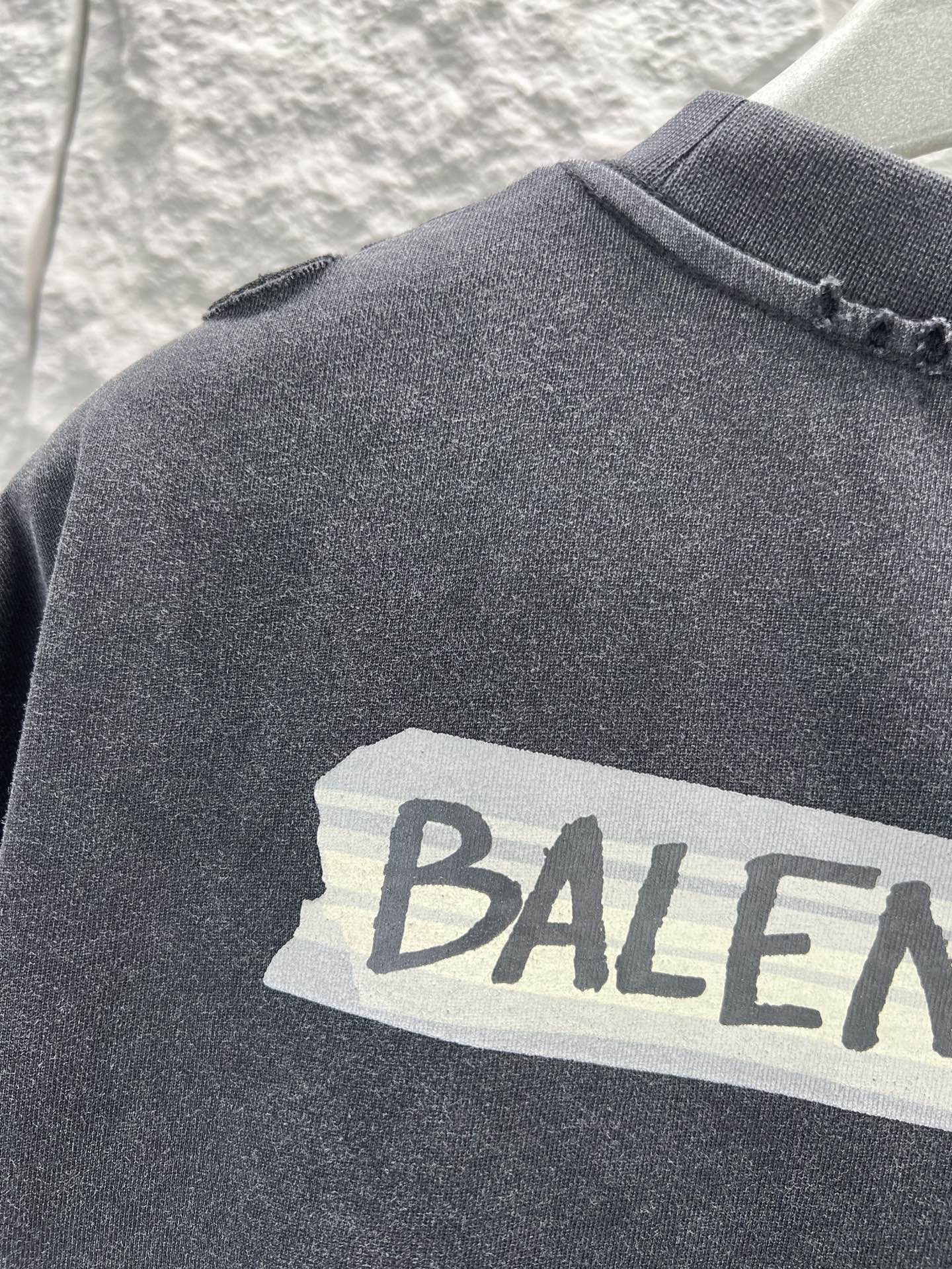 Dark heather T-shirt with large Balenciaga text graphic close-up