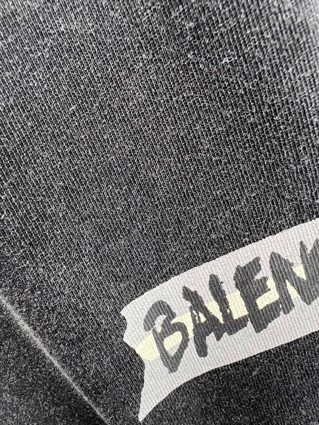 Balenciaga logo printed on dark heather T-shirt fabric close-up