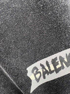 Balenciaga logo printed on dark heather T-shirt fabric close-up