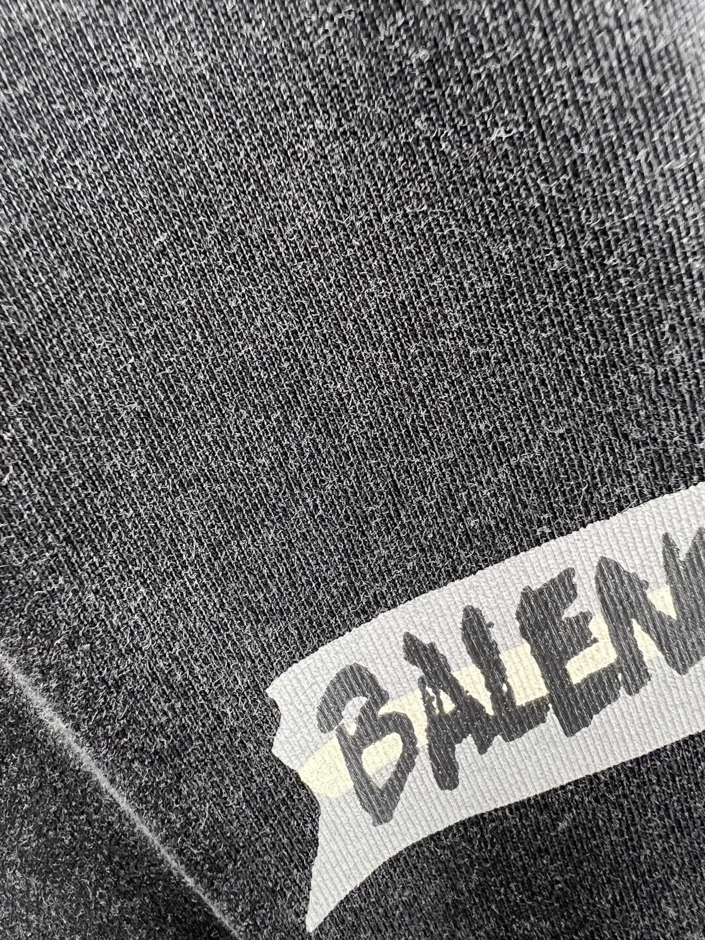 Balenciaga logo printed on dark heather T-shirt fabric close-up