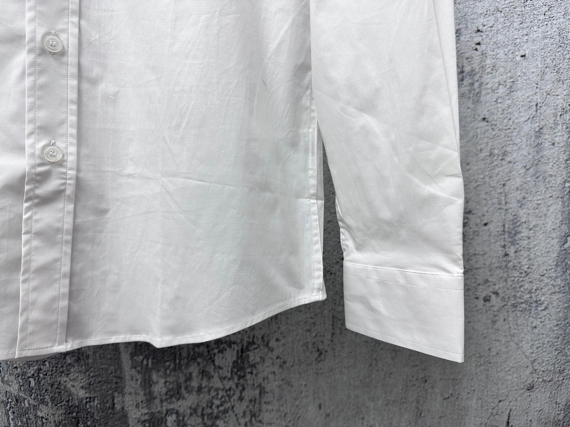 Long-sleeve button-up shirt sleeve and hem, white, with front stitching details