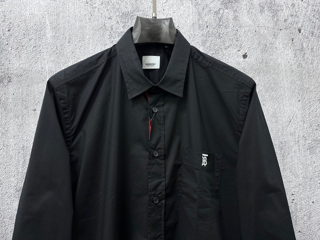 Long-sleeve button-up shirt, dark; front view with chest logo and button placket