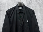 Long-sleeve button-up shirt, dark; front view with chest logo and button placket