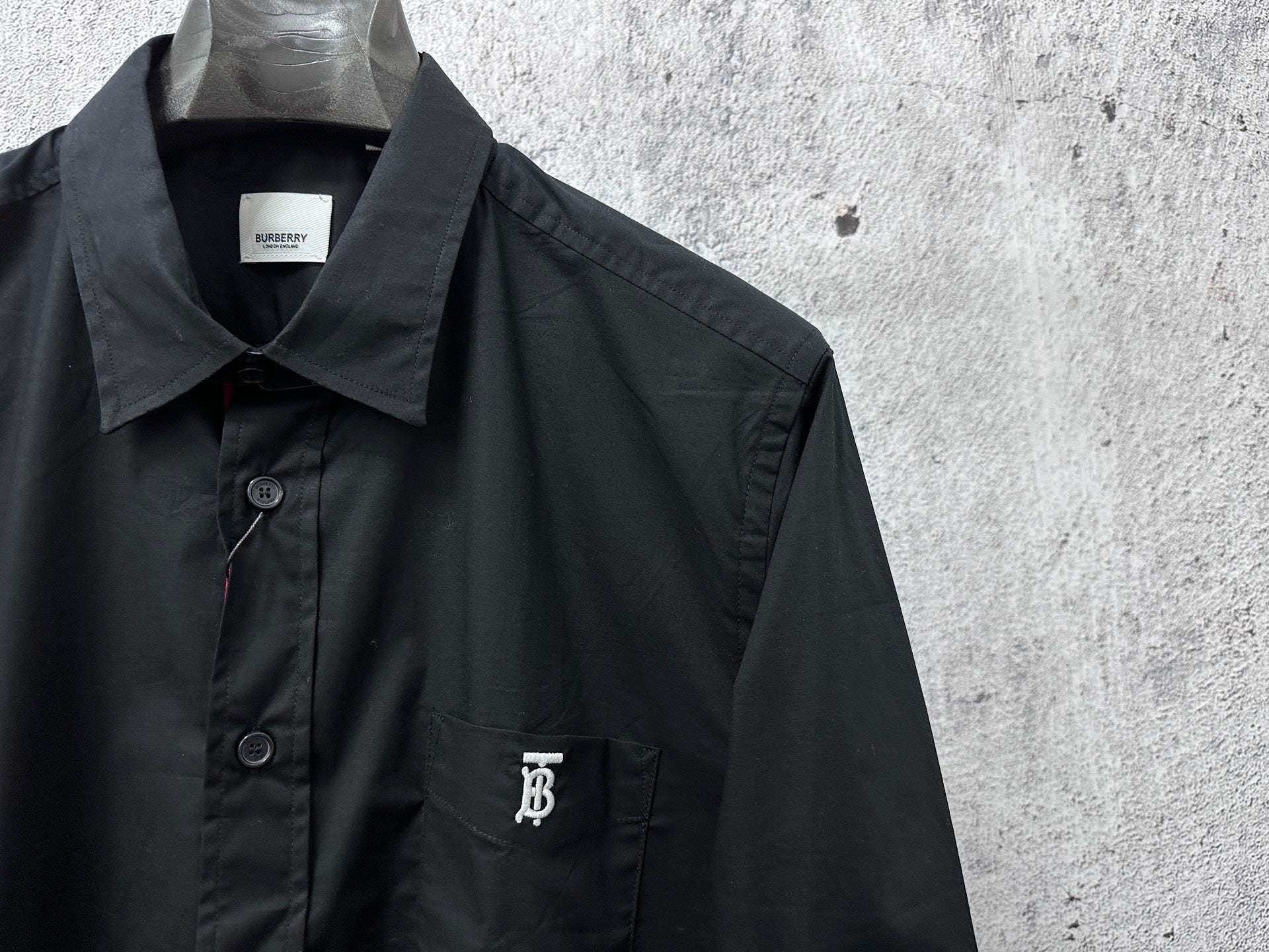 Burberry long-sleeve shirt front close-up with button placket and chest logo
