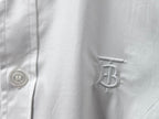 Burberry white shirt chest monogram patch and button close-up