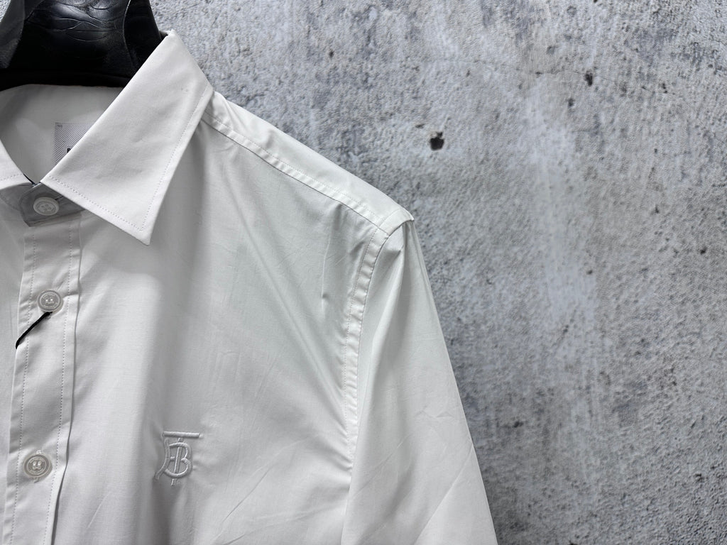 Burberry white button-up shirt close-up of shoulder seam, cuff, and stitched detail