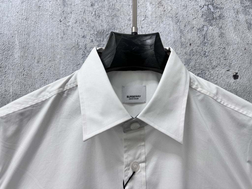 Burberry white button-up shirt with pointed collar, placket buttons, and inner label