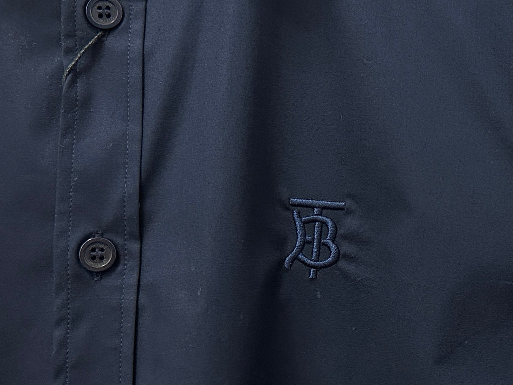 Navy shirt fabric with button at placket and embroidered B logo