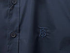 Navy shirt fabric with button at placket and embroidered B logo