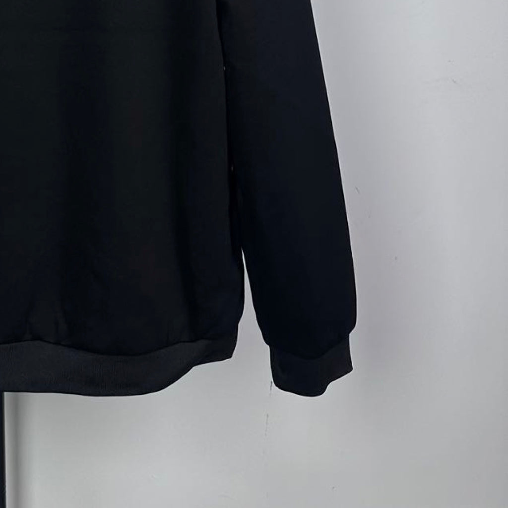 Long dark coat hem and long sleeve cuff