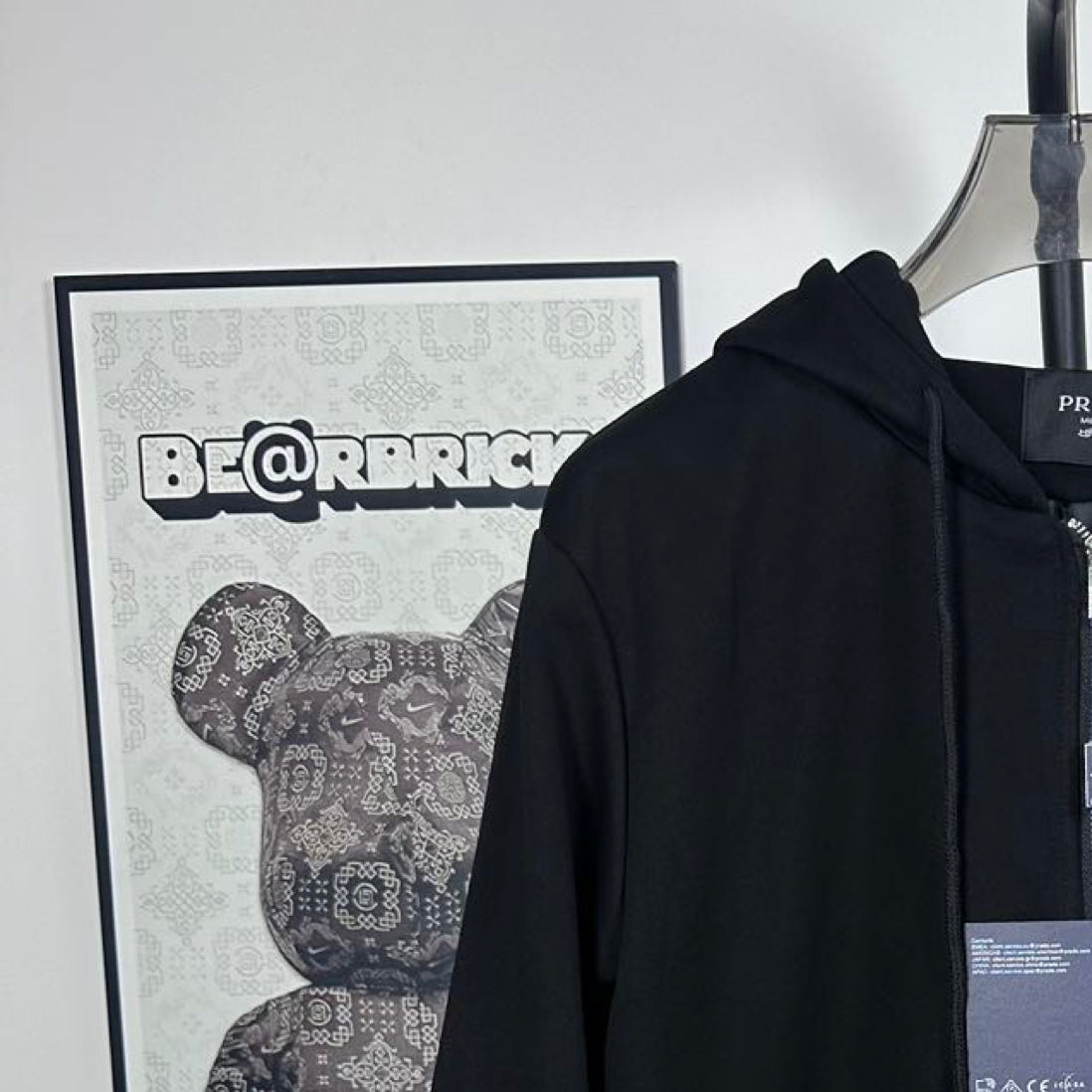 Black Prada hoodie with drawstring hood and triangle chest logo detail