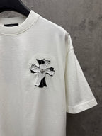 White short-sleeve T-shirt with small cross applique graphic on chest
