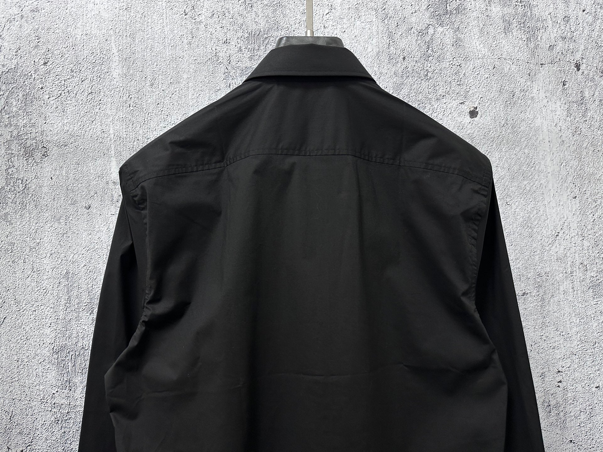 Black button-up shirt, back view with center yoke and shoulder shaping