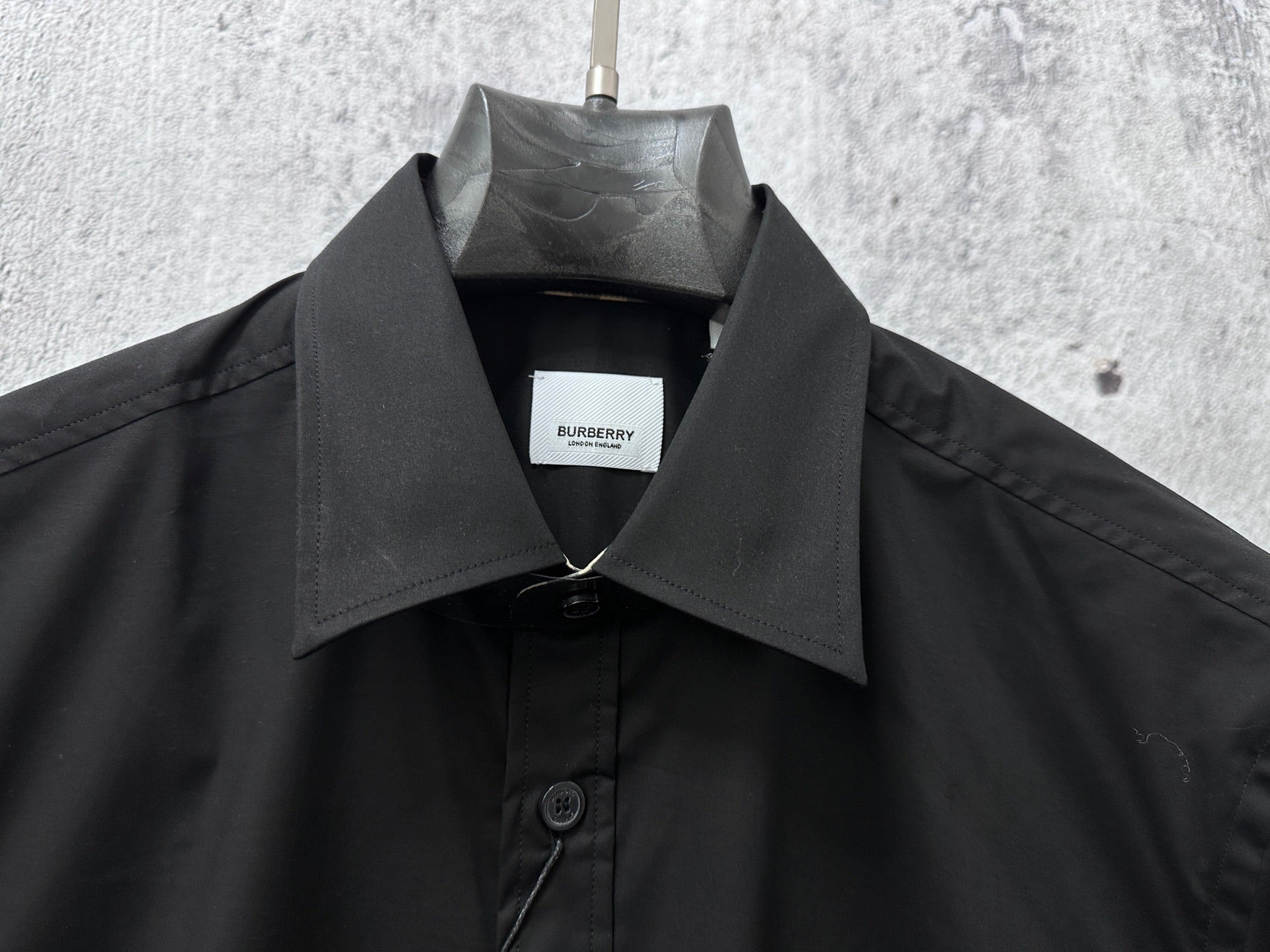 Black Burberry button-up shirt collar with front button placket