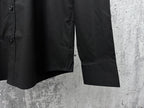 Black button-up shirt sleeve cuff with stitched hem