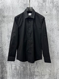 Black button-up shirt with pointed collar and front button placket