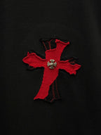 Red cross applique with fleur-de-lis detail on black T-shirt fabric