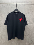 Black short-sleeve T-shirt with small red cross emblem on chest