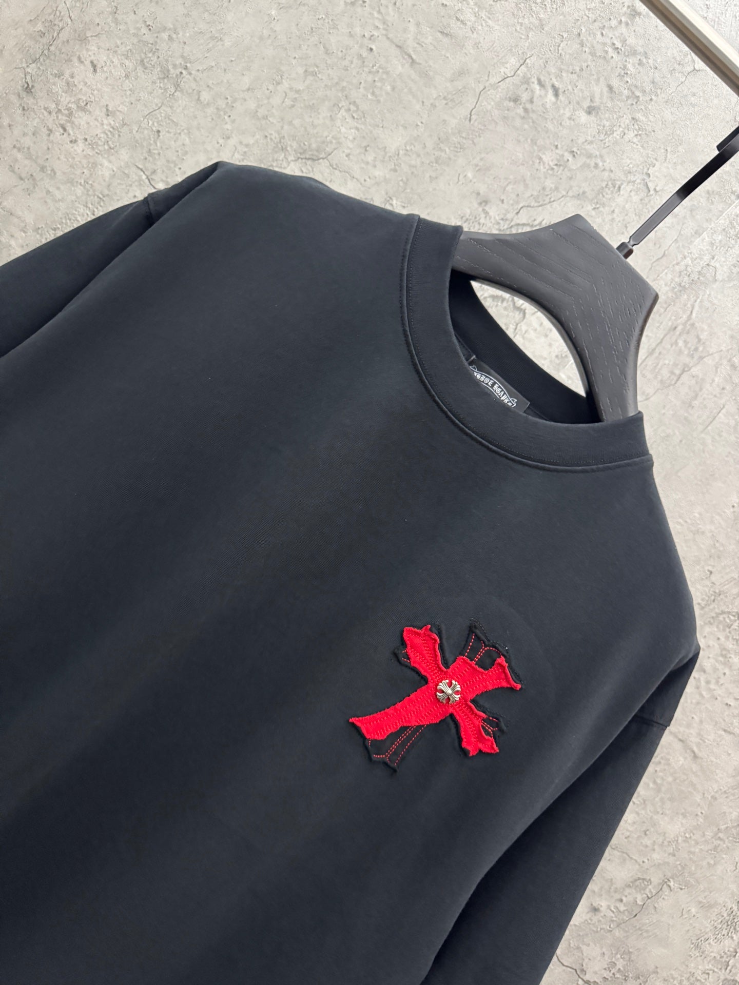 Dark navy short-sleeve T-shirt with red cross chest patch detail